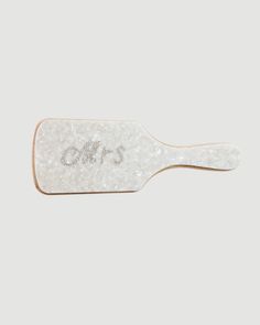 a white hair brush with the word's on it