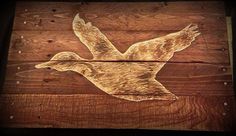 an image of a bird carved into wood