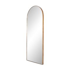 a mirror that is sitting on top of a wall next to a white wall with a wooden frame