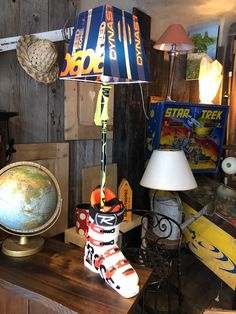 a lamp that is sitting on top of a wooden table in front of a globe