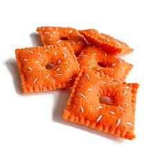 small crackers with white sprinkles are arranged on a white table top