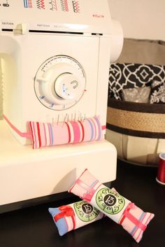 two candy bars sitting on top of a sewing machine next to an appliance