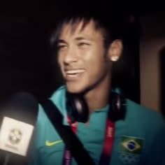 a man with headphones on smiling at the camera