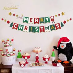 a table topped with cupcakes and christmas decorations