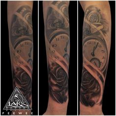 the arm is covered in tattoos and has a clock on it with roses growing out of it