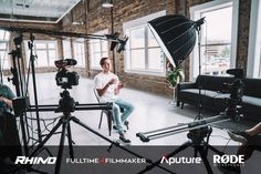 a man sitting in front of a camera on top of a tripod