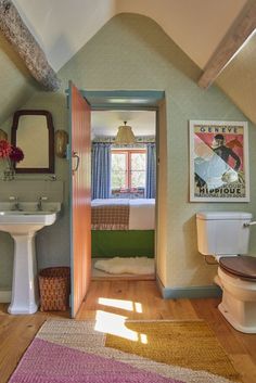 a bathroom with a toilet, sink and mirror