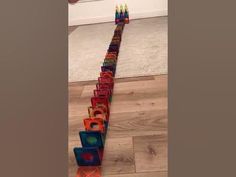 a long row of colorful blocks sitting on top of a wooden floor