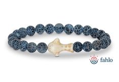 a bracelet made out of blue and white beads with a bone in the middle on a white background