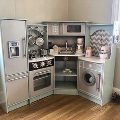 a toy kitchen with appliances and accessories in it