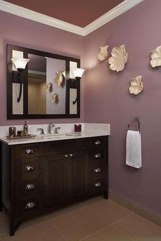 a bathroom with purple walls and two sinks