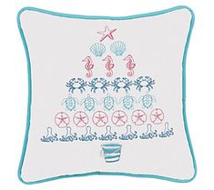 a white pillow with blue trim and seahorses on the bottom, under a starfish tree