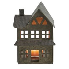 a lit up house shaped like a dollhouse with windows on the front and side