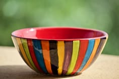 a colorful bowl sitting on top of a wooden table