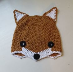 a crocheted hat with a fox face on it