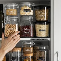 a person reaching for some food in a pantry