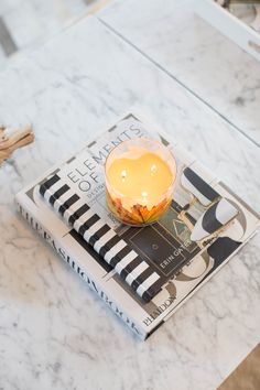 a candle is sitting on top of a book