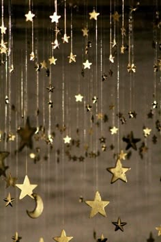 the stars and moon are hanging from the ceiling