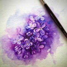 a watercolor painting of purple flowers on a white paper with a black pen next to it