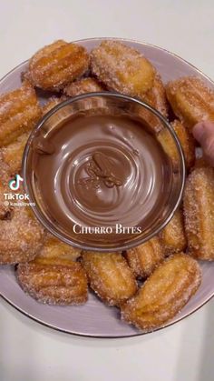 a plate with donuts and dipping sauce on it