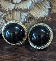 1980s Large Round Dome Black & Gold Clip-on Earrings.  Love these! Retro Black Round Earrings, Black Retro Clip-on Jewelry, Vintage Round Metal Clip-on Earrings, Vintage Round Clip-on Earrings With Cabochon, Vintage Black Clip-on Earrings, Black Vintage Round Clip-on Earrings, Vintage Black Round Clip-on Earrings, Black Vintage Clip-on Earrings, Vintage Yellow Gold Round Clip-on Earrings