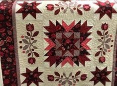 a red and white quilt with stars on it