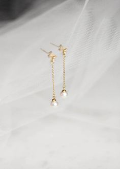 The traditional pearl drop has been reimagined for the minimalist bride. No fuss and without the frills, the Pablo earrings are striking in simplicity. Accented by petite Swarovski pearls, these elegant drops will add a modern finish to your bridal look. Available in silver or gold tones. Please leave your colour preference in the message box at checkout. * DETAILS * > Designed and handmade in Australia. Worldwide shipping > Sterling silver or gold filled chain and posts, Swarovski pearls, Dainty Pearl Charm Linear Earrings For Wedding, Minimalist Drop Earrings For Wedding, Timeless Wedding Pearl Earrings With Pearl Chain, Dainty Bridal Earrings With Pearl Drop, Minimalist Pearl White Pearl Earrings For Wedding, Minimalist Pearl White Pearl Drop Bridal Earrings, Minimalist Pearl White Bridal Earrings With Pearl Drop, Timeless Bridal Earrings With Pearl Drop, Timeless Pearl Drop Bridal Earrings For Wedding