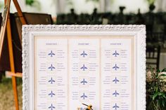 an airplane seating chart is displayed in front of a chair and easel on the grass