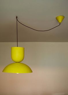 a yellow lamp hanging from the ceiling in a room