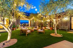 an outdoor living area with grass and lights