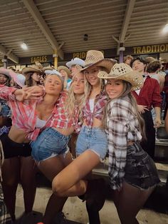 several girls in cowboy hats posing for the camera