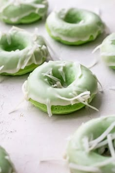 green donuts with white icing and sprinkles