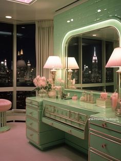 a green vanity with two lamps on it and a pink stool in front of the mirror