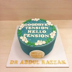 there is a cake on the table that says goodbye tension, hello pension and dr abdul rezlak