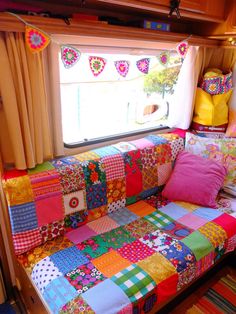 a brightly colored couch sitting in front of a window