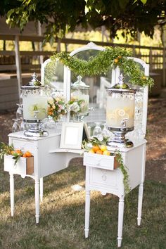 an old vanity is decorated with greenery and candles for the bride's wedding