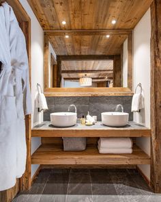 a bathroom with two sinks and a large mirror