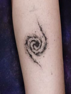 a black and white spiral tattoo on the left arm with space in the back ground