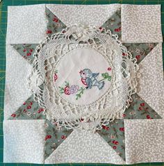 a close up of a piece of cloth on a table with a star shaped doily