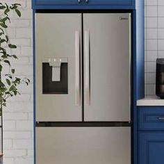 a silver refrigerator freezer sitting inside of a kitchen next to a blue counter top