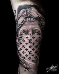 a man's arm with tattoos on it and an image of a woman covering his face