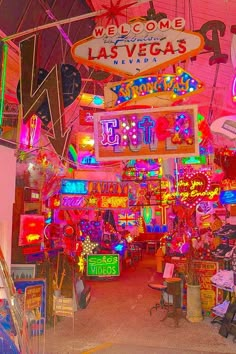 neon signs are hanging from the ceiling in this las vegas shop filled with brightly colored lights