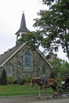 a horse drawn carriage in front of a church