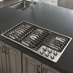 a stove top sitting on top of a kitchen counter