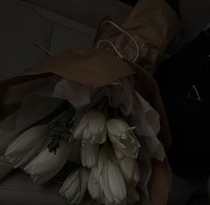 a bouquet of white flowers sitting on top of a car seat