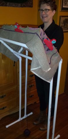 a woman standing next to an ironing board