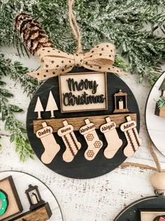 a christmas ornament with stockings and stockings hanging from it's side on a table