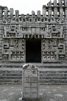 an ancient stone structure with carvings on it