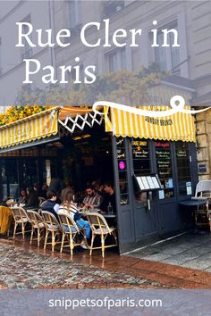 people sitting at tables in front of a restaurant with yellow and white awnings