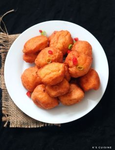 a white plate topped with tater tots on top of a black tablecloth